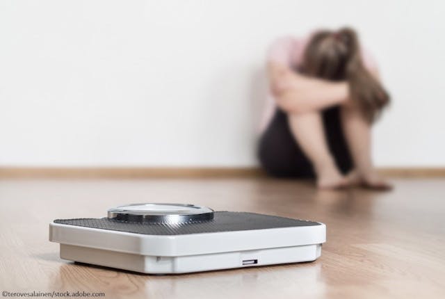 Eating Disorder Hospitalizations Rising among US Adolescents, Finds New Research / image credit sad female and scale: ©terovesalainen/stock.adobe.com