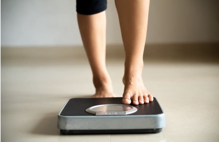 person stepping on a weight scale